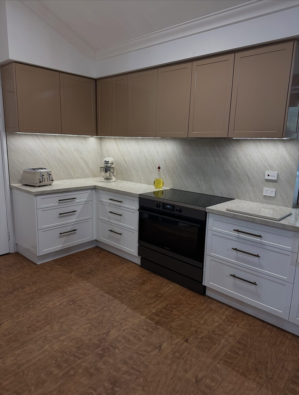 After: two-tone shaker-style cabinetry with a black freestanding oven