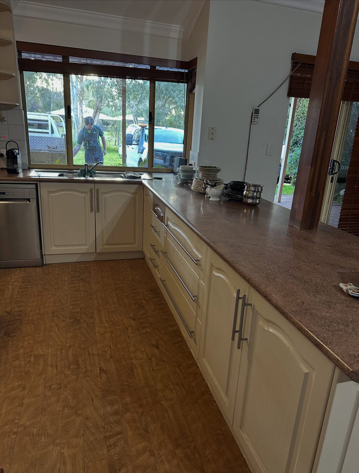 Before: the old bench run with dark laminate top under the window