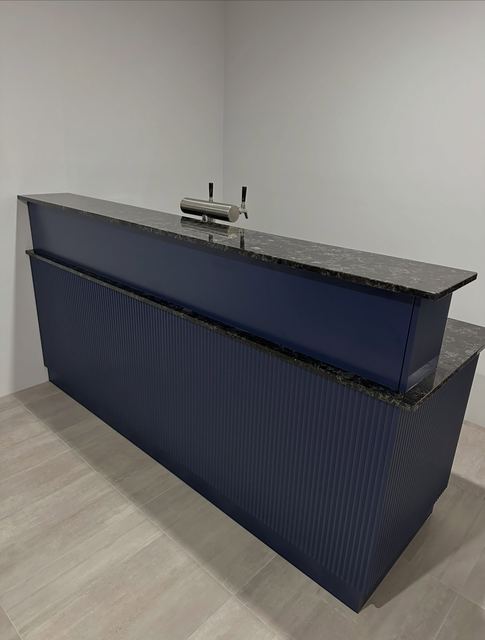 Fluted navy bar with a granite benchtop